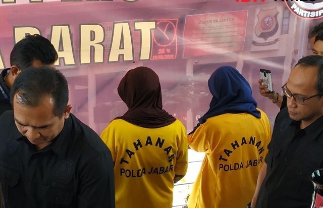 Dua tersangka membelakangi wartawan ketika konferensi pers siang tadi